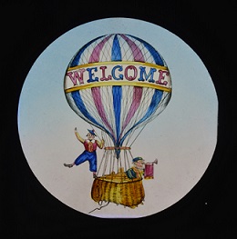 Lantern slide of a hot air ballon with the word Welcome on it